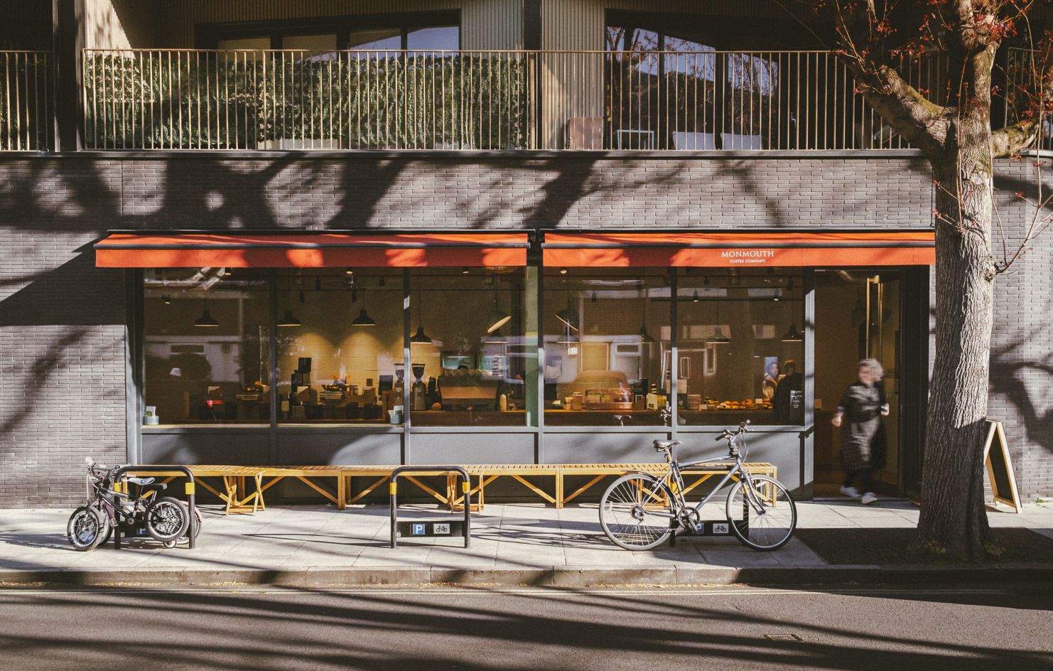 Monmouth Coffee Company's black-and-orange shopfront on Dockley Road, Bermondsey
